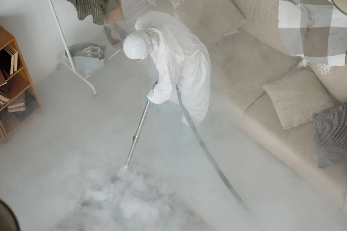 Biohazard cleanup technician in protective equipment, Cañoncito, NM